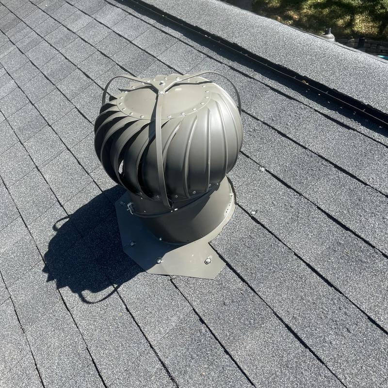 Attic roof turbine vent on asphalt shingles Attic roof turbine vent on asphalt shingles