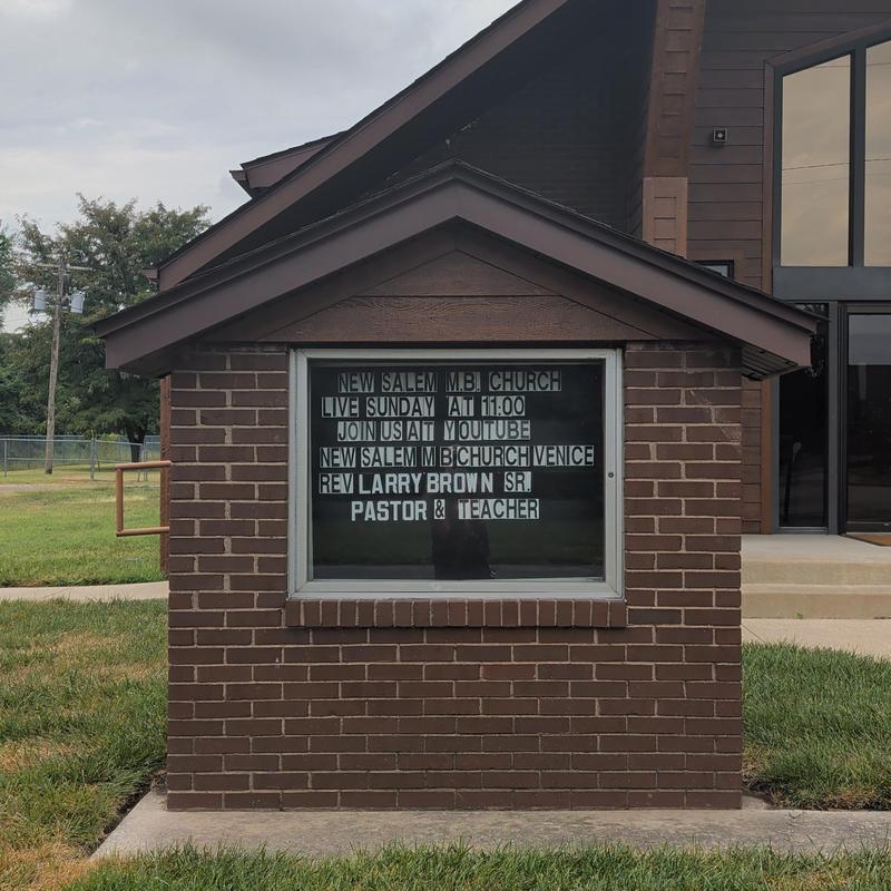 Church outdoor message board with schedule and names