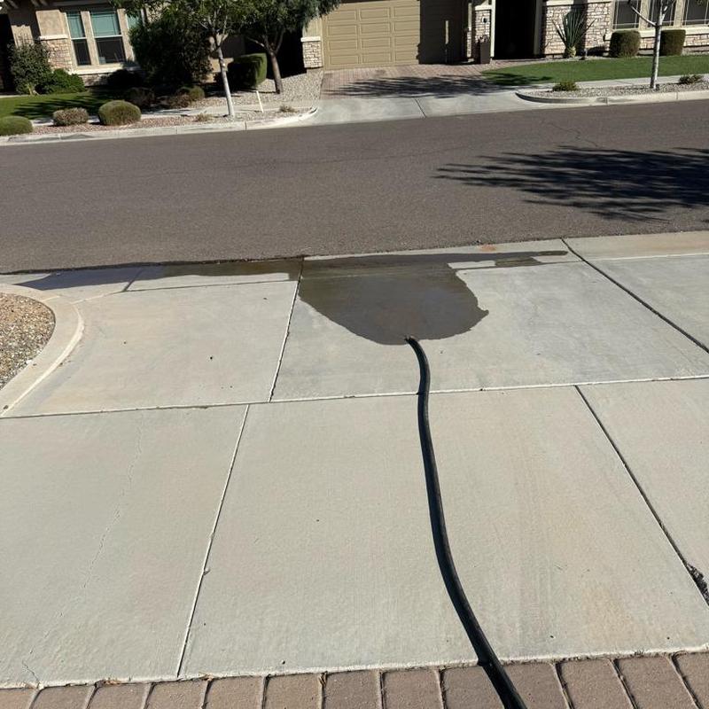 Softener brine tank flushing with hose on driveway