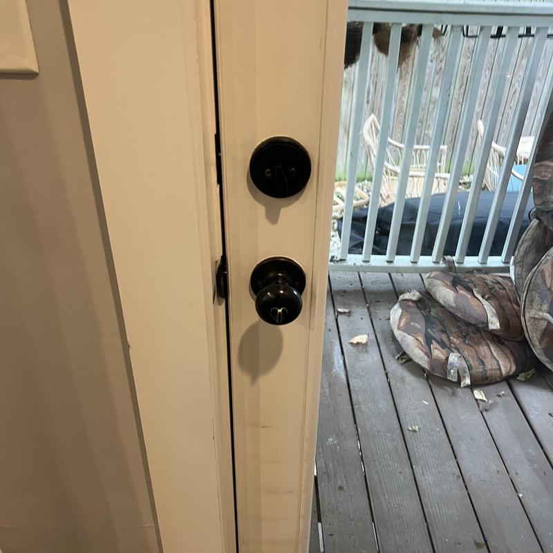 Door locks on white door with outdoor deck background Door locks on white door with outdoor deck background