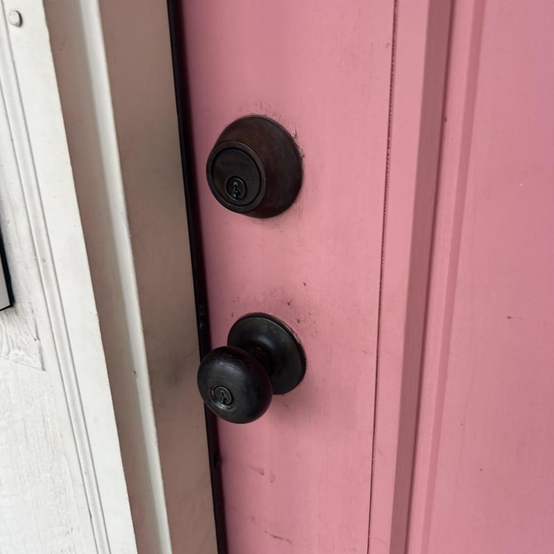 Deadbolt and door knob locks on pink door Deadbolt and door knob locks on pink door