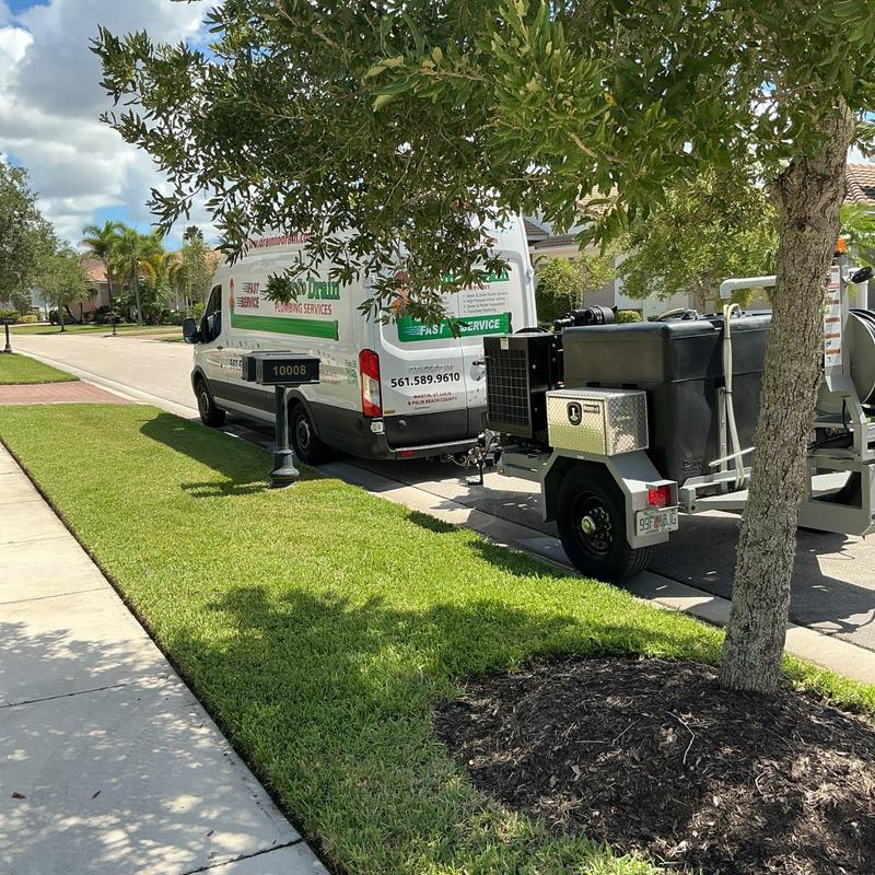 Residential sewer jetting truck and plumbing van parked Residential sewer jetting truck and plumbing van parked