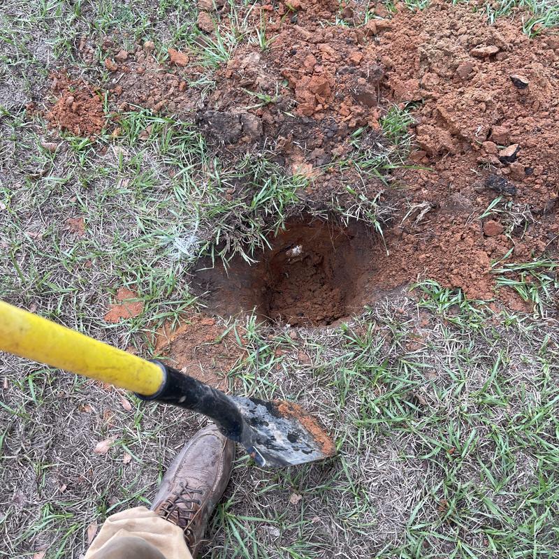 Main sewer line excavation with shovel in yard soil Main sewer line excavation with shovel in yard soil