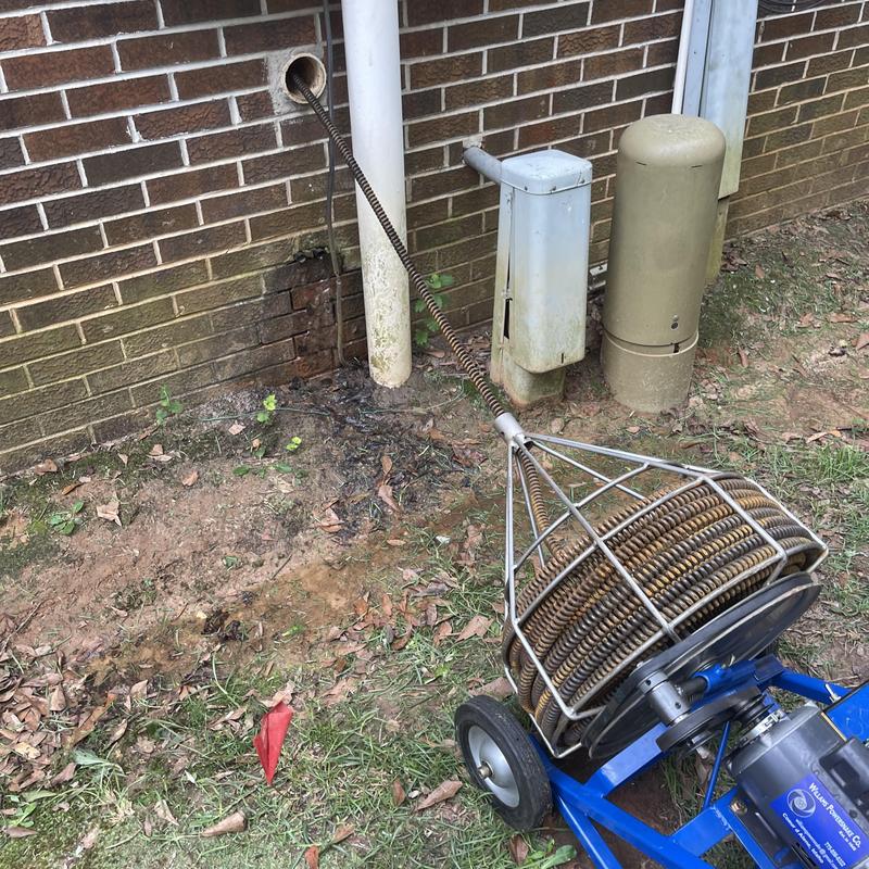 Mainline sewer cleaning cable inserted in exterior pipe Mainline sewer cleaning cable inserted in exterior pipe