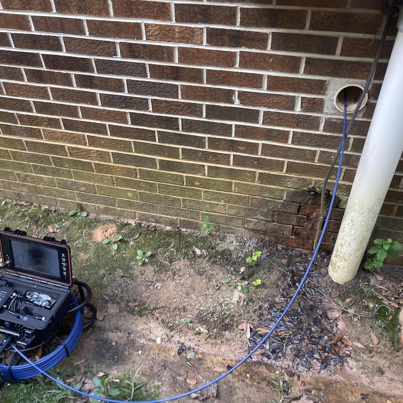 Main sewer line camera inspection at brick wall exterior Main sewer line camera inspection at brick wall exterior