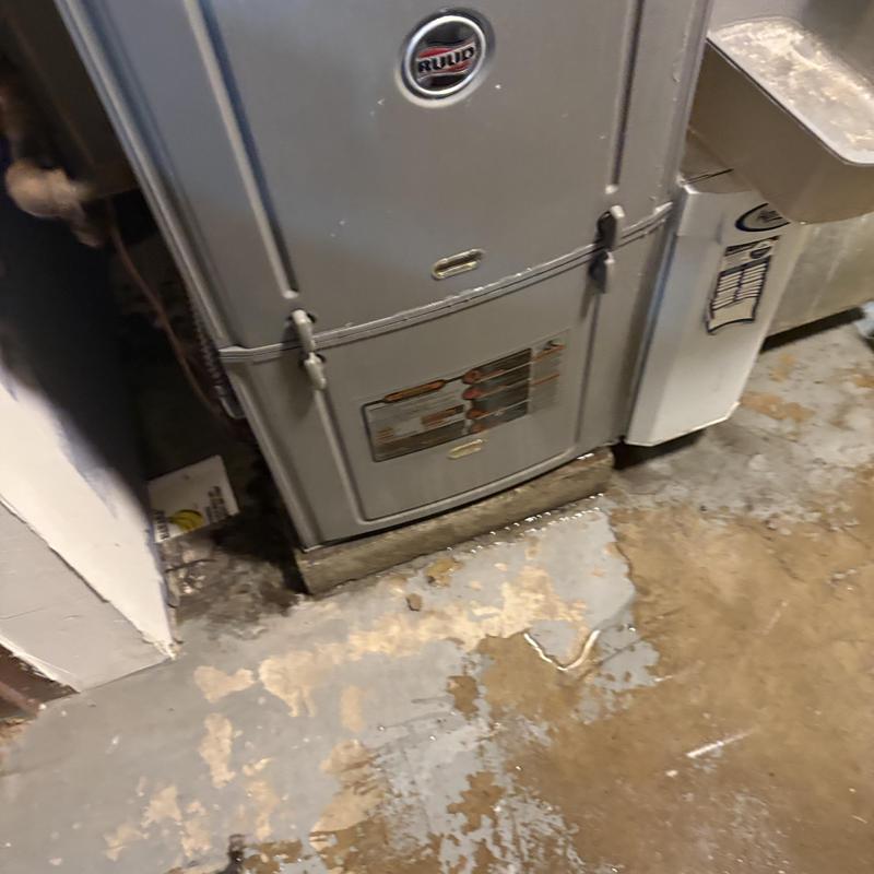 Furnace unit with water leakage on basement floor Furnace unit with water leakage on basement floor
