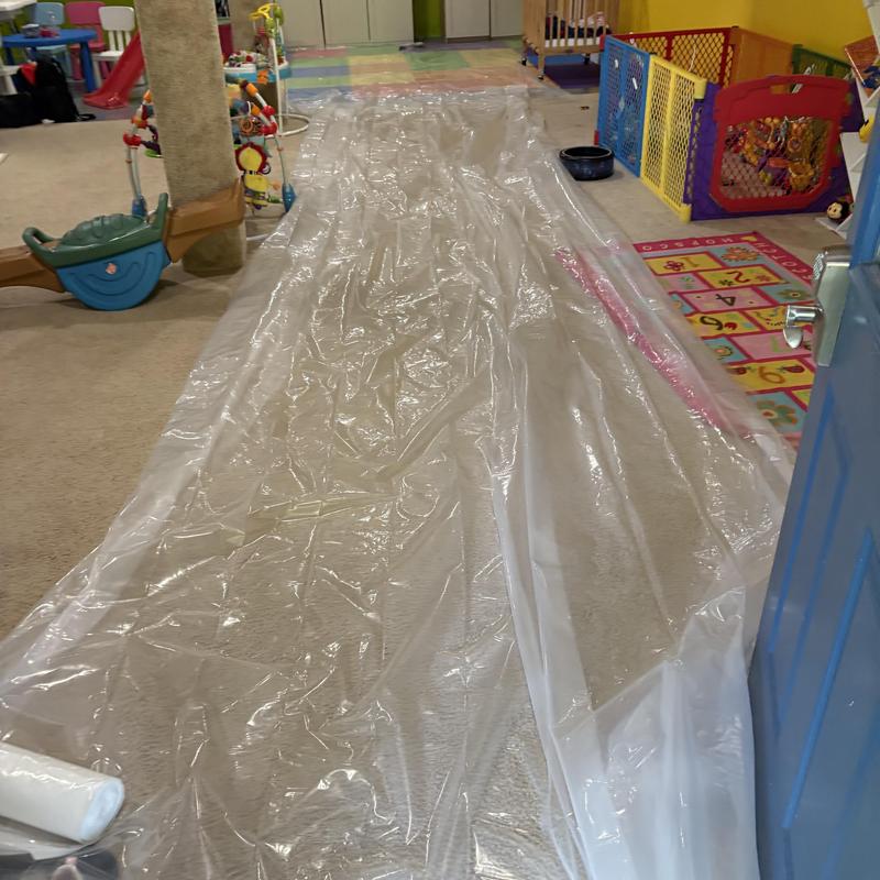 Plastic protective sheeting laid on carpeted floor in playroom Plastic protective sheeting laid on carpeted floor in playroom