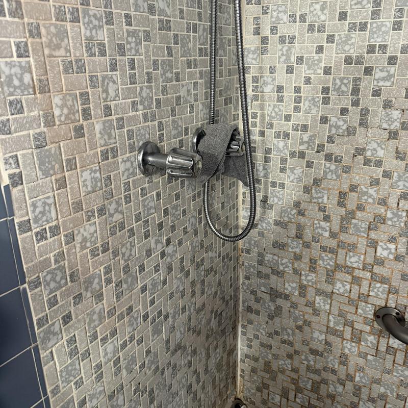 Shower valve with handheld showerhead and tiled wall Shower valve with handheld showerhead and tiled wall