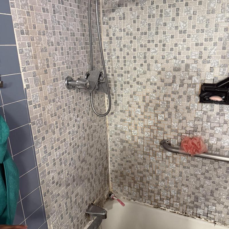 Bathroom shower faucet and tiled wall with grab bar Bathroom shower faucet and tiled wall with grab bar