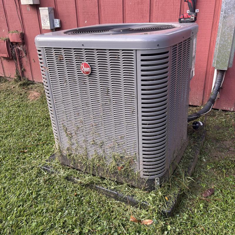 Rheem outdoor air conditioner unit with grass debris Rheem outdoor air conditioner unit with grass debris