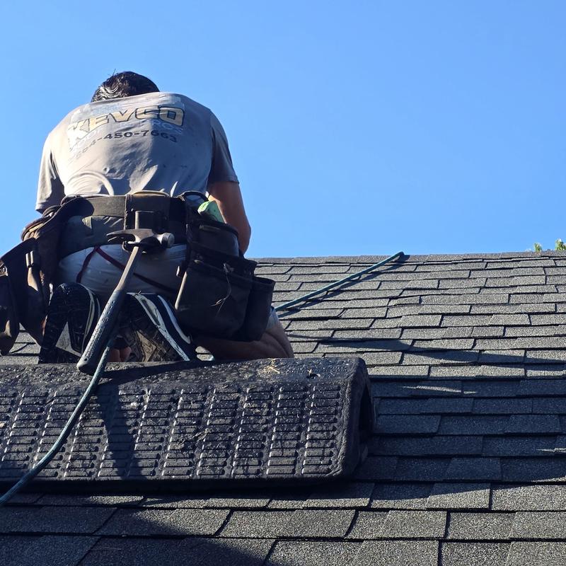Roof shingles with nail pop repairs in progress Roof shingles with nail pop repairs in progress