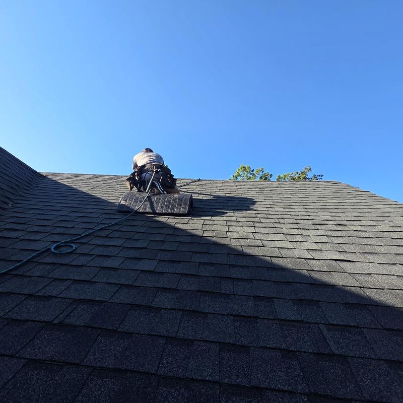 Asphalt shingle roof nail pop repairs with roofer knees pad Asphalt shingle roof nail pop repairs with roofer knees pad