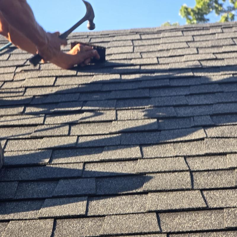 Asphalt roof shingles nail pop repair with hammer Asphalt roof shingles nail pop repair with hammer