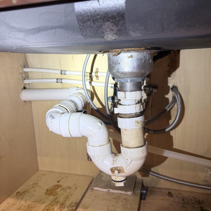 Kitchen sink drain pipes under cabinet with new fittings Kitchen sink drain pipes under cabinet with new fittings