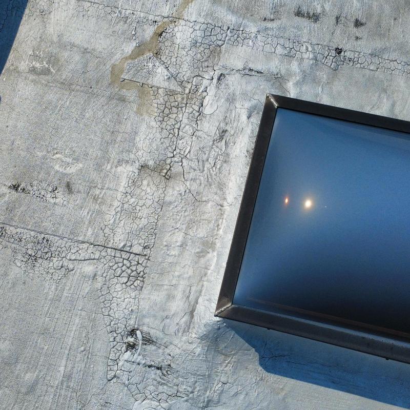 TPO roof with cracked sealant around skylight