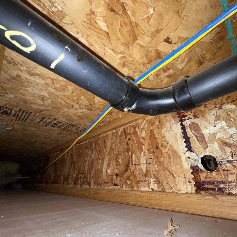 ABS branch drain line with new fittings near floor joist ABS branch drain line with new fittings near floor joist