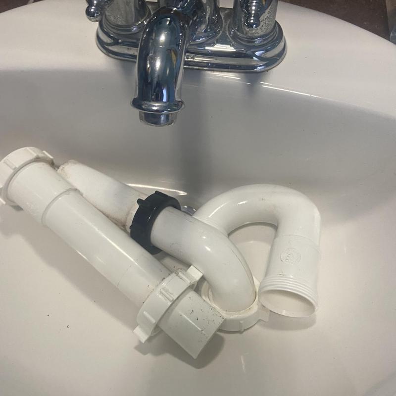 Sink drain pipes disconnected under faucet in basin Sink drain pipes disconnected under faucet in basin