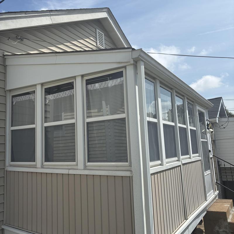 Enclosed porch windows and siding on residential home