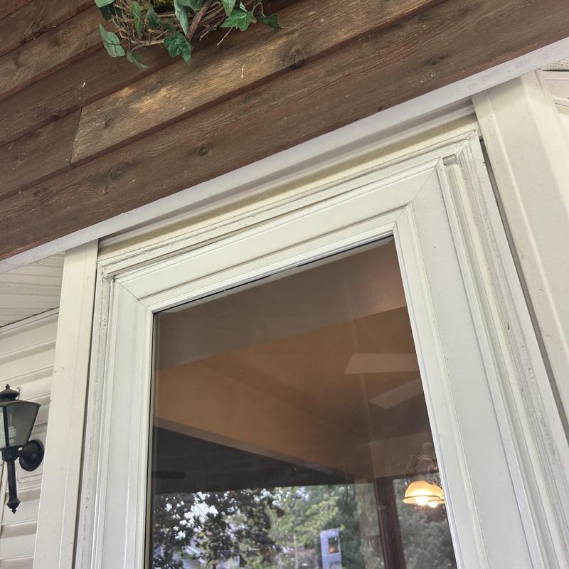 Wood siding above rear door with soffit trim damage Wood siding above rear door with soffit trim damage