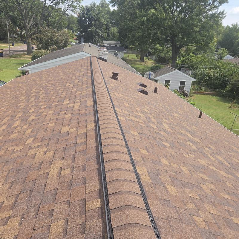 Asphalt shingle roof with ridge vent and vents