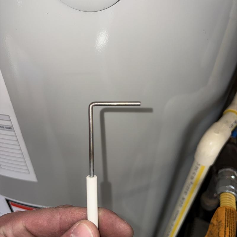 Furnace flame sensor with cleaning tool held by hand Furnace flame sensor with cleaning tool held by hand