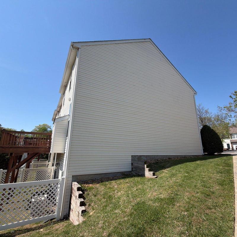 Vinyl siding exterior wall with lawn and deck