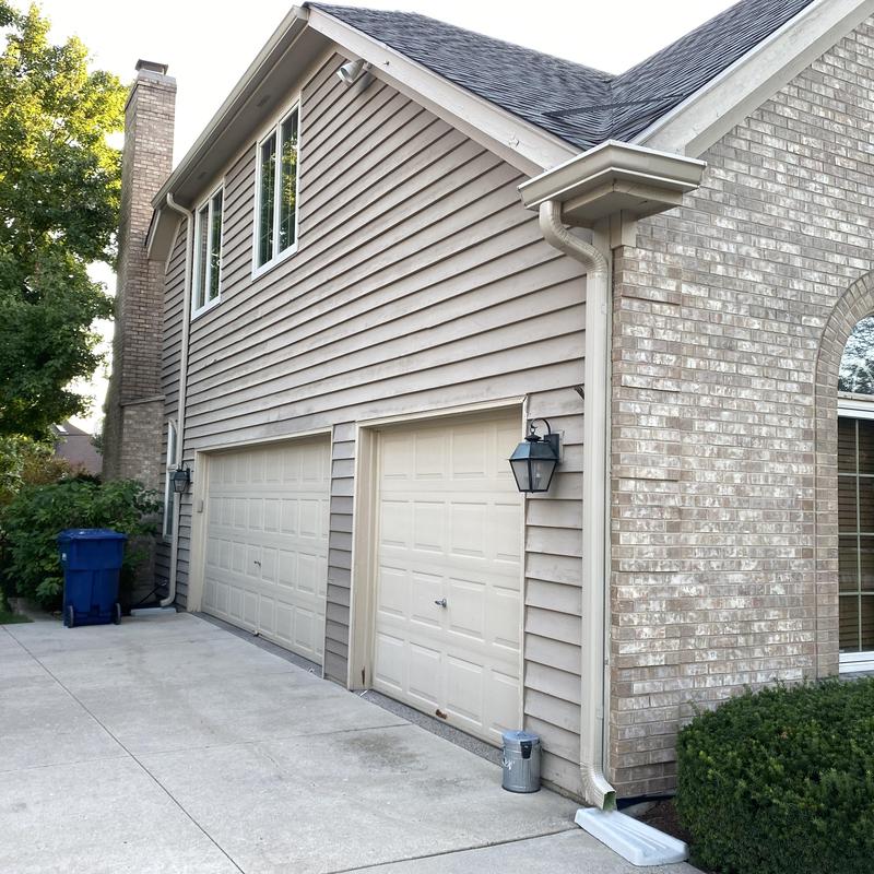 Gutter and downspout system on residential home exterior