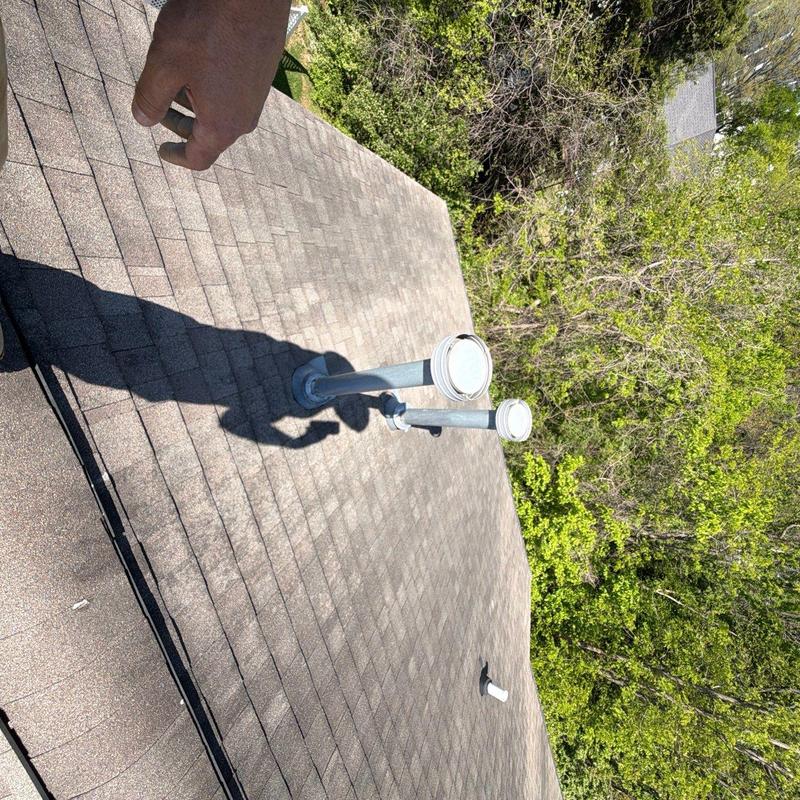 Asphalt shingle roofing with vent pipes on residential roof