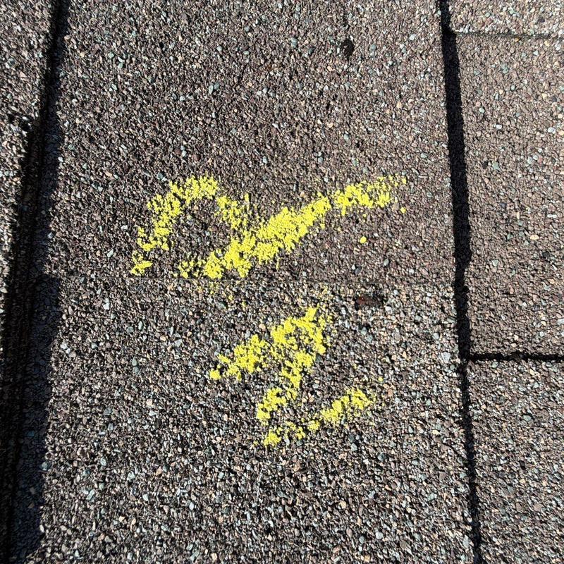 Asphalt shingle roof with marked hail damage