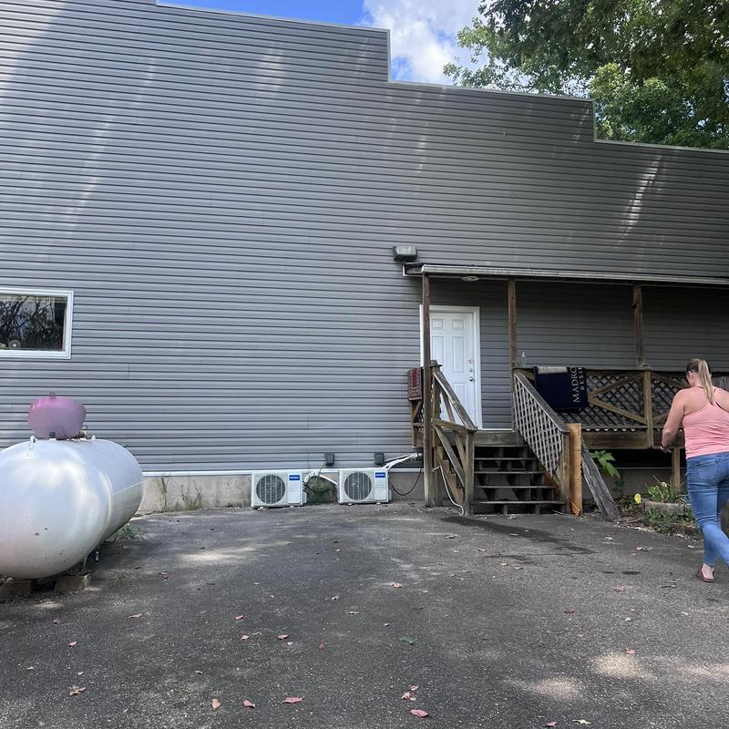 Elm Grove vinyl siding wall with porch and tanks