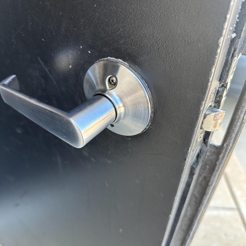 Keypad lever lock on black metal door close-up Keypad lever lock on black metal door close-up