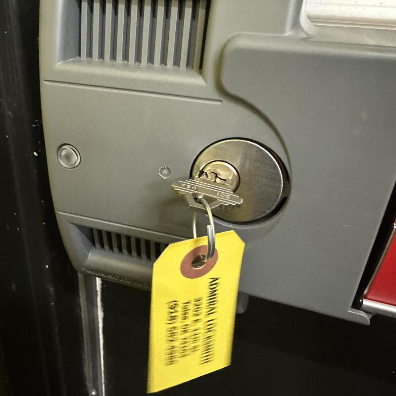 Lock cylinder with new key and tag attached Lock cylinder with new key and tag attached