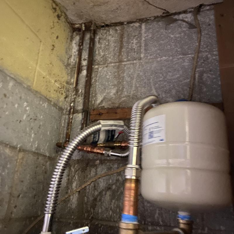 Expansion tank and flexible water lines in basement wall Expansion tank and flexible water lines in basement wall