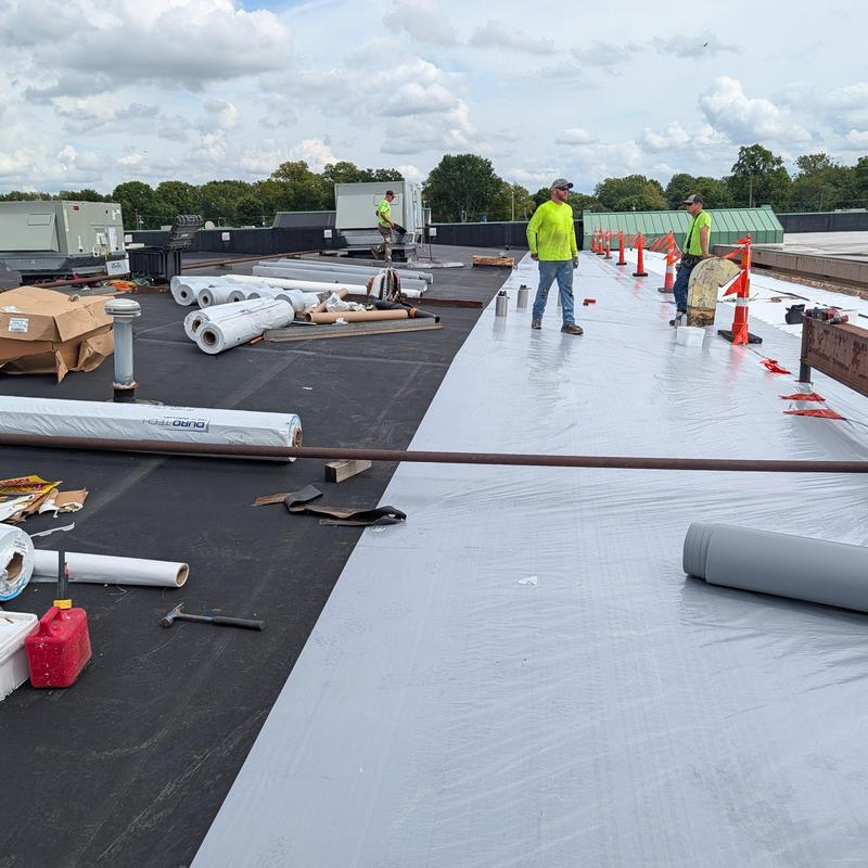 TPO Single Ply Roof Restoration with workers on flat roof
