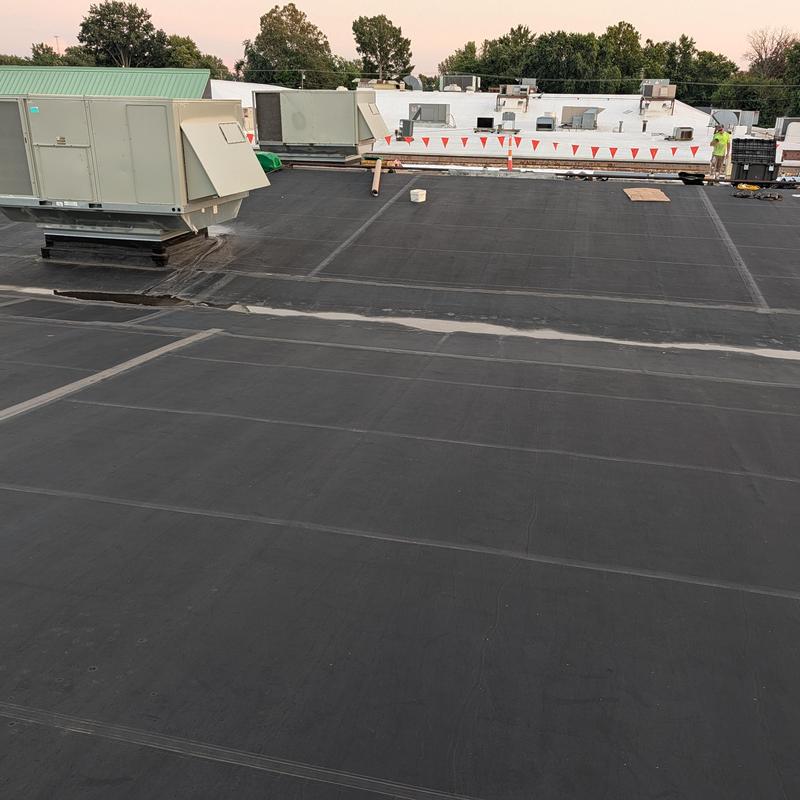 EPDM rubber flat roof with HVAC units and crew