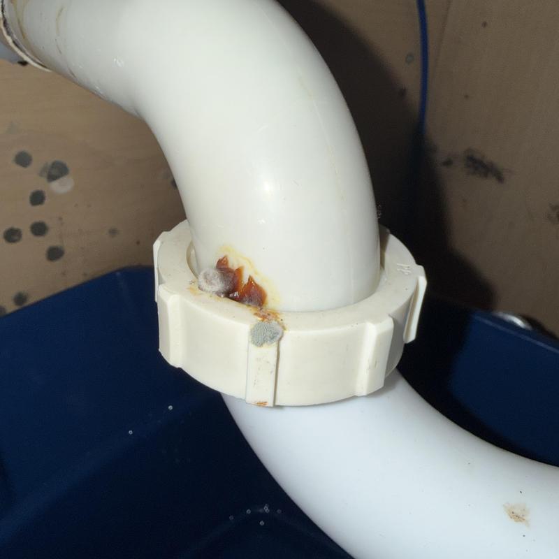 Bathroom sink drain pipe with corrosion and mold buildup
