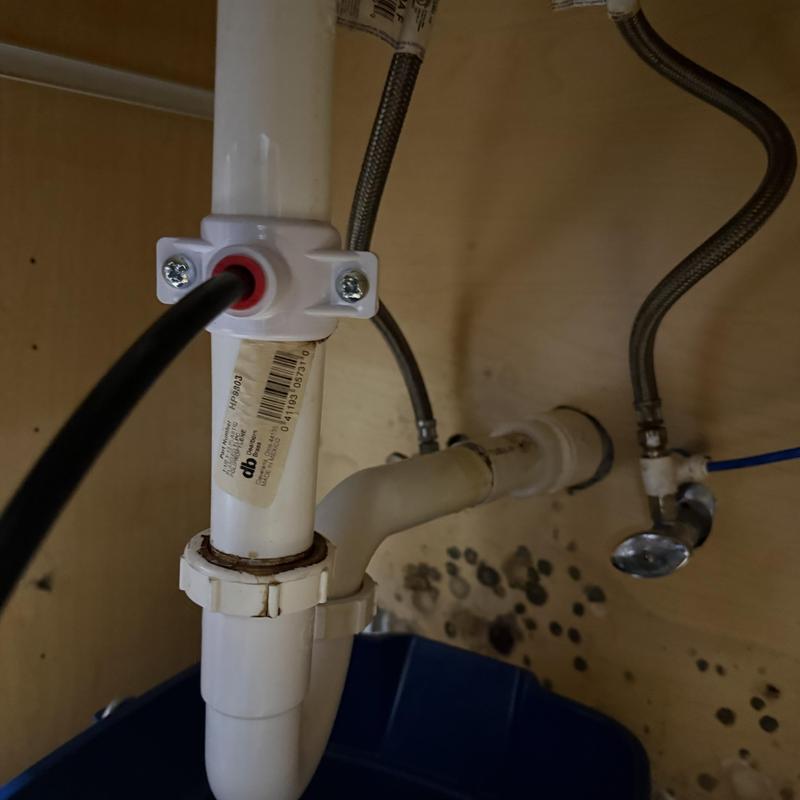 Bathroom sink drain pipe and supply lines under cabinet