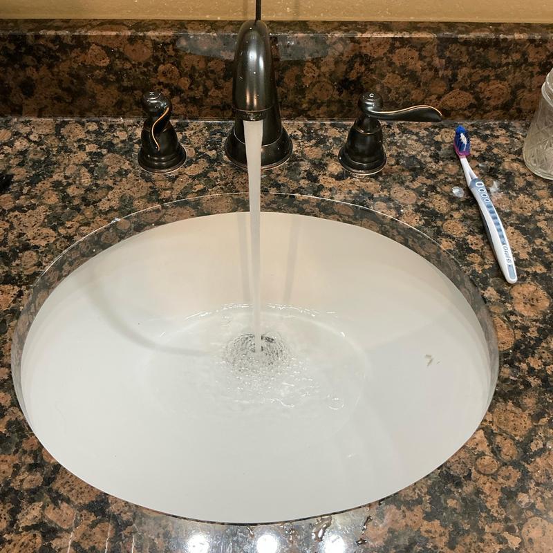 Bathroom sink drain clearing with water flow Bathroom sink drain clearing with water flow