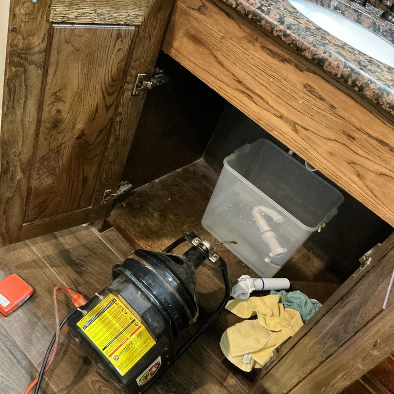 Lavatory drain with cleaning cable and tools under sink Lavatory drain with cleaning cable and tools under sink