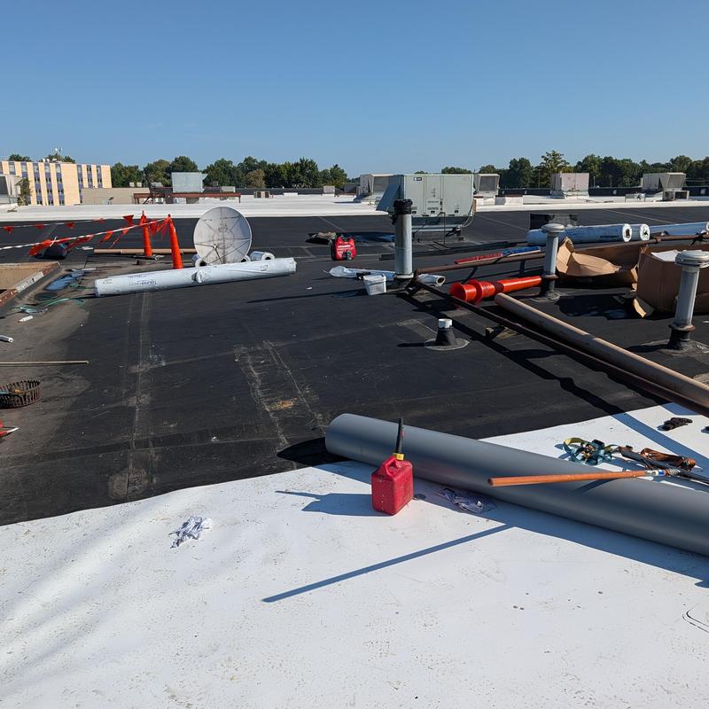 TPO single ply roofing with restoration materials on rooftop