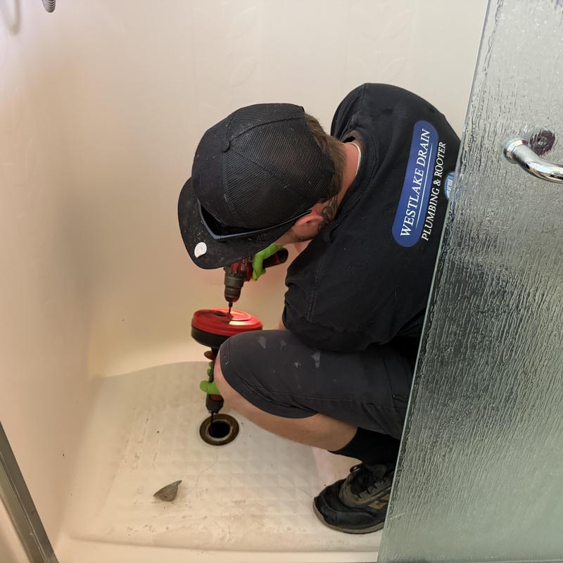 Shower drain clearing using roto rooter tool Shower drain clearing using roto rooter tool