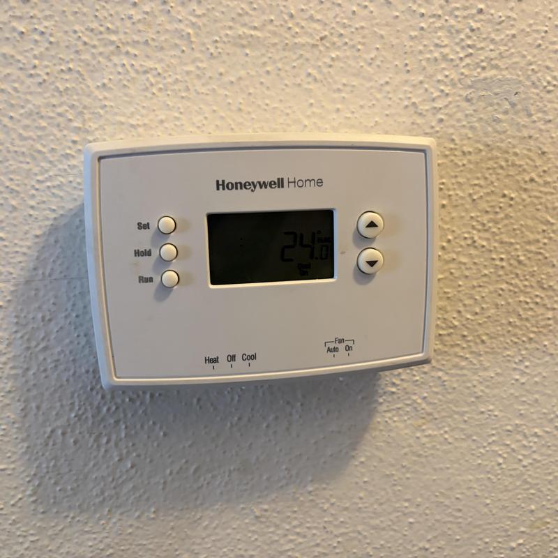 Honeywell thermostat displaying temperature setting Honeywell thermostat displaying temperature setting