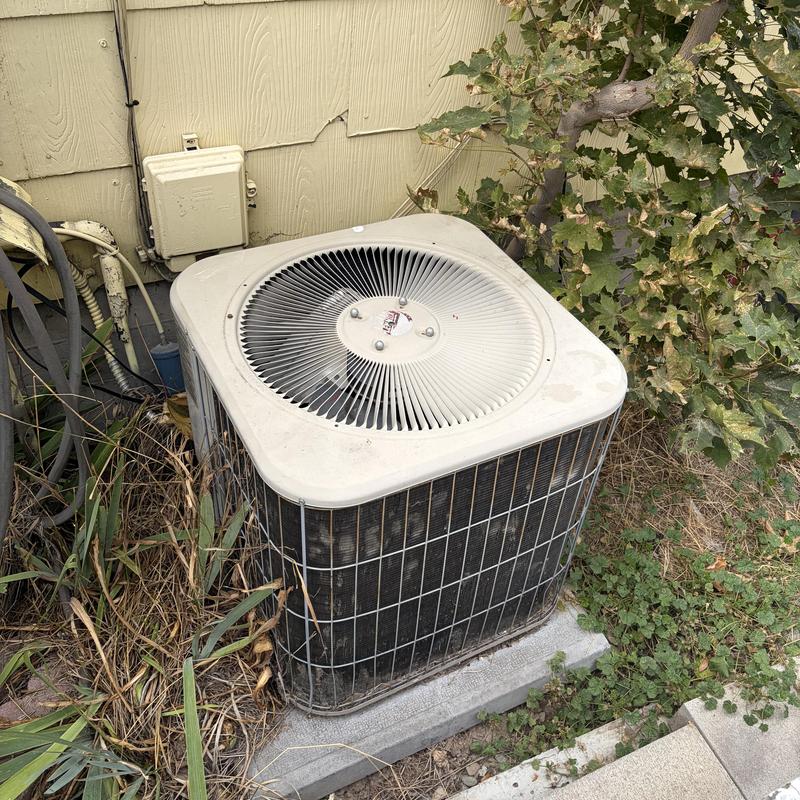 Outdoor air conditioner unit with debris nearby Outdoor air conditioner unit with debris nearby