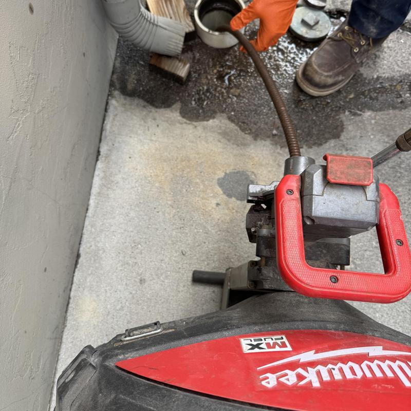 Grease trap cleanout with drain snake machine Grease trap cleanout with drain snake machine
