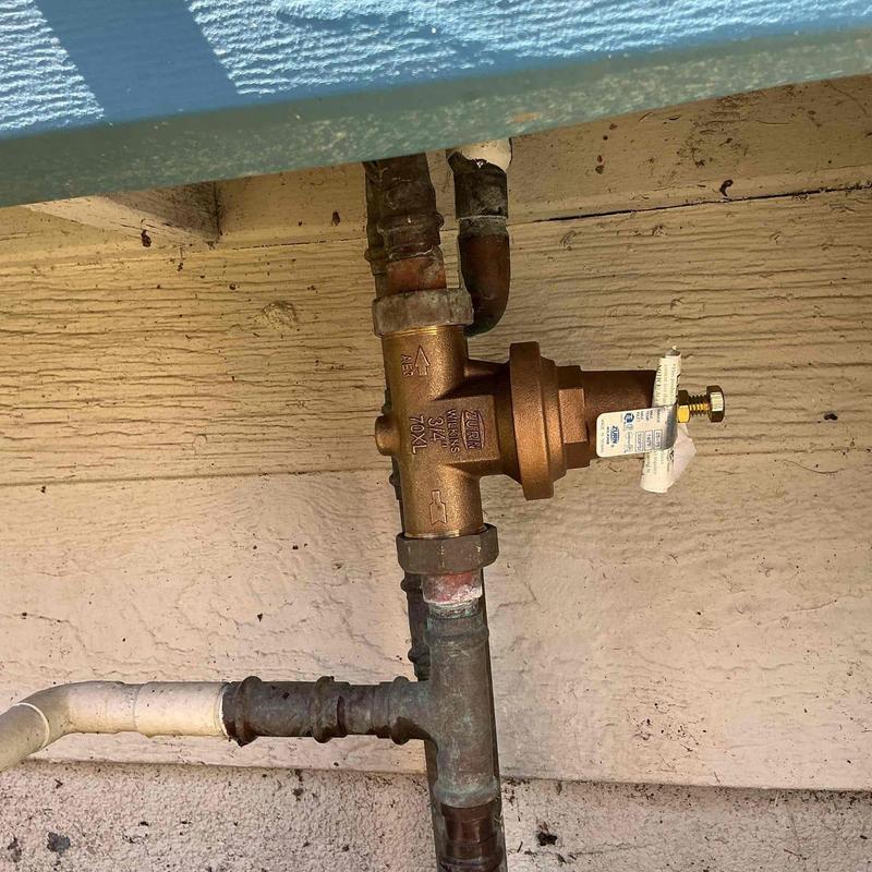 Pressure regulator valve on metal plumbing pipe system Pressure regulator valve on metal plumbing pipe system