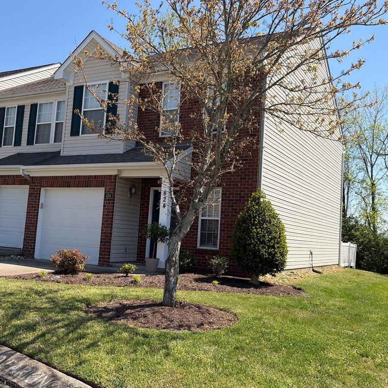 Roofing system with tree and landscaping in front