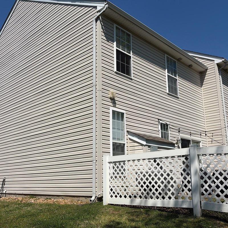 Vinyl siding exterior on residential townhouse with fence