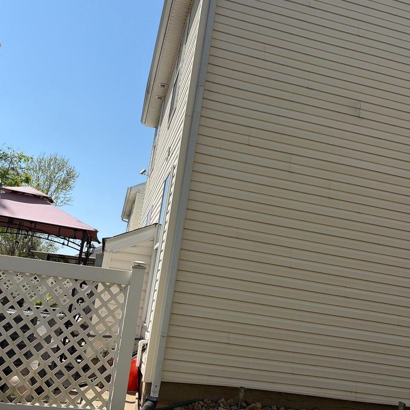 Vinyl siding exterior wall with lattice fence and gazebo
