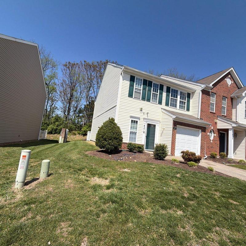 Residential asphalt shingle roof exterior and lawn view
