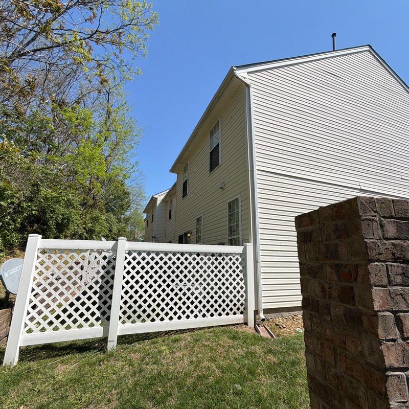 Vinyl lattice fence panel beside residential building